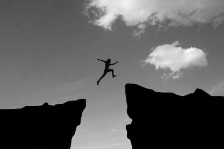 man-jump-through-gap-hill-man-jumping-cliff-sunset-background-business-concept-idea BW